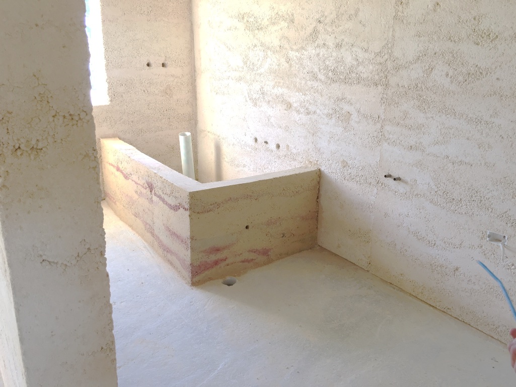  That is one BIG (and beautiful) rammed earth bath!  